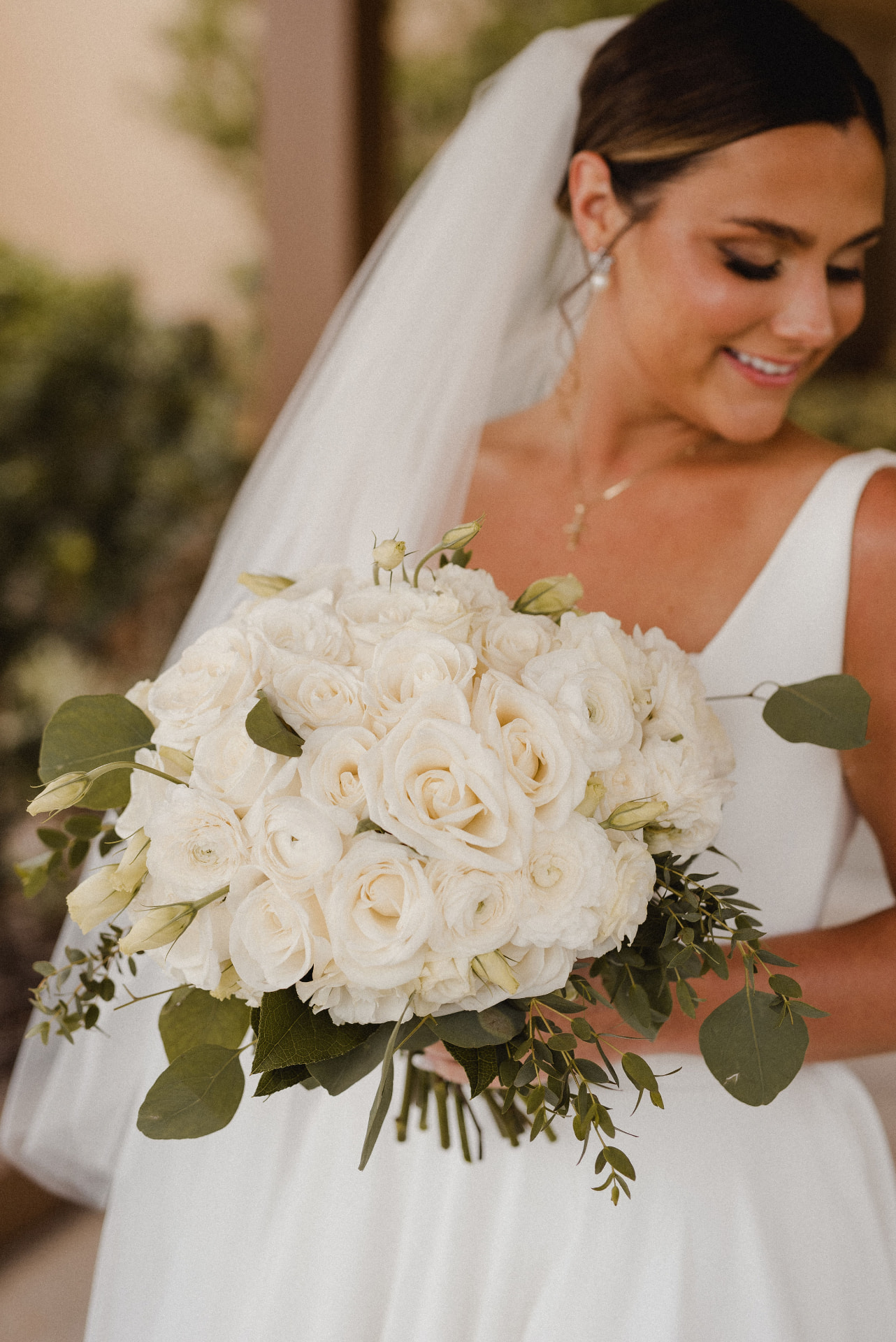 Bride holding a white rose bouquet