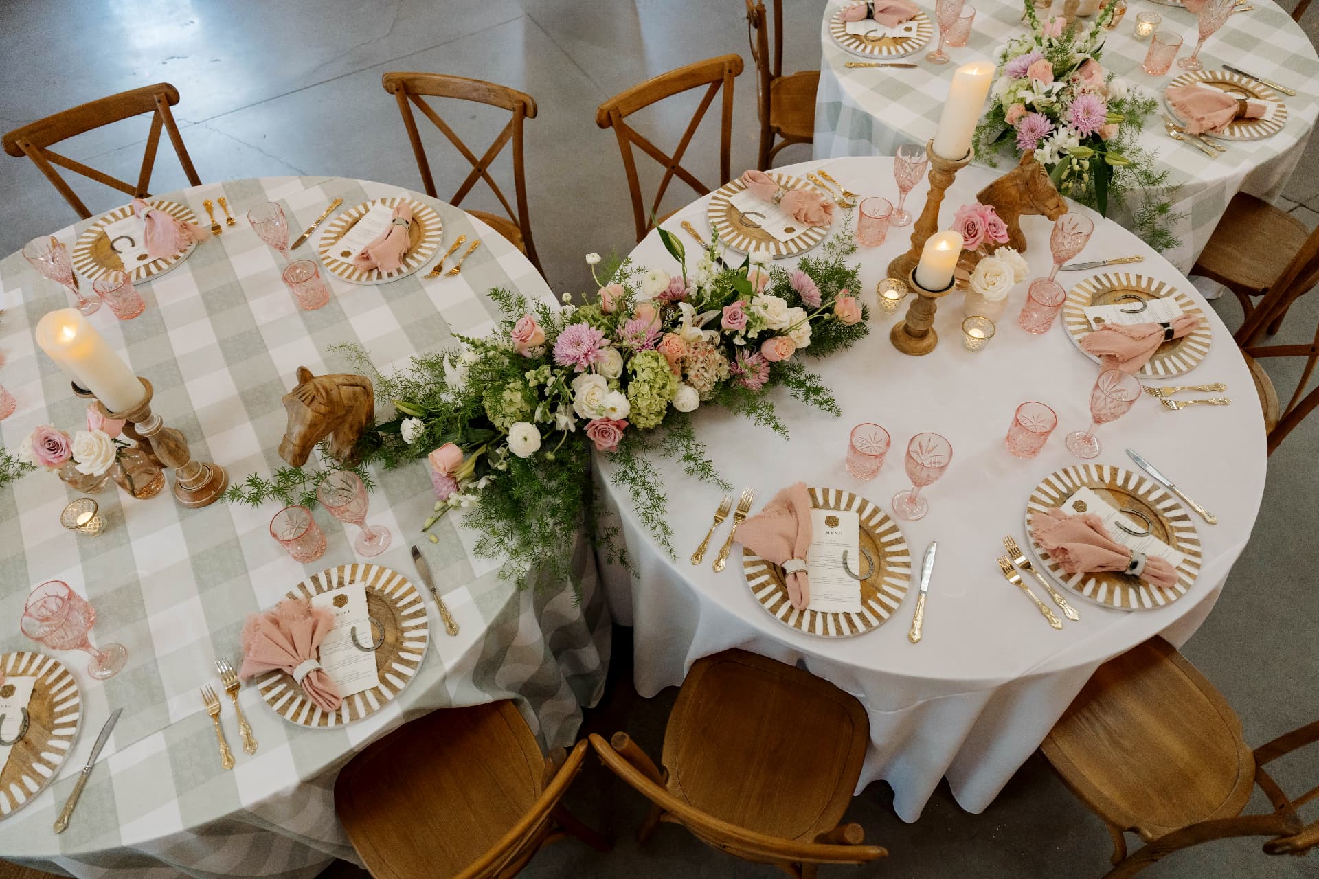 Reception tables with pink florals and candles