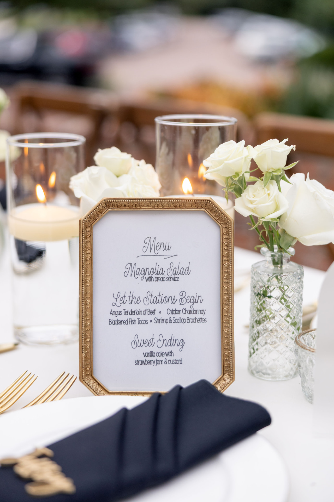 Gold-framed menu with white roses