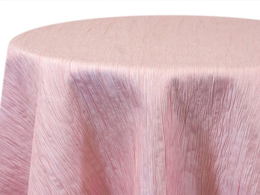 Blush pink crinkle-texture tablecloth draped over a round table