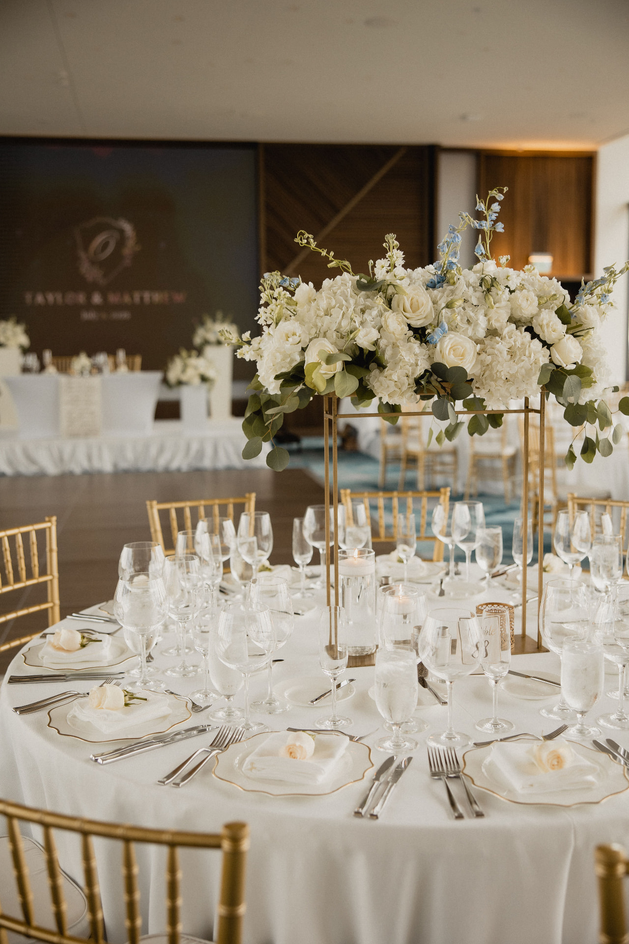 Gold centerpiece stand with white florals