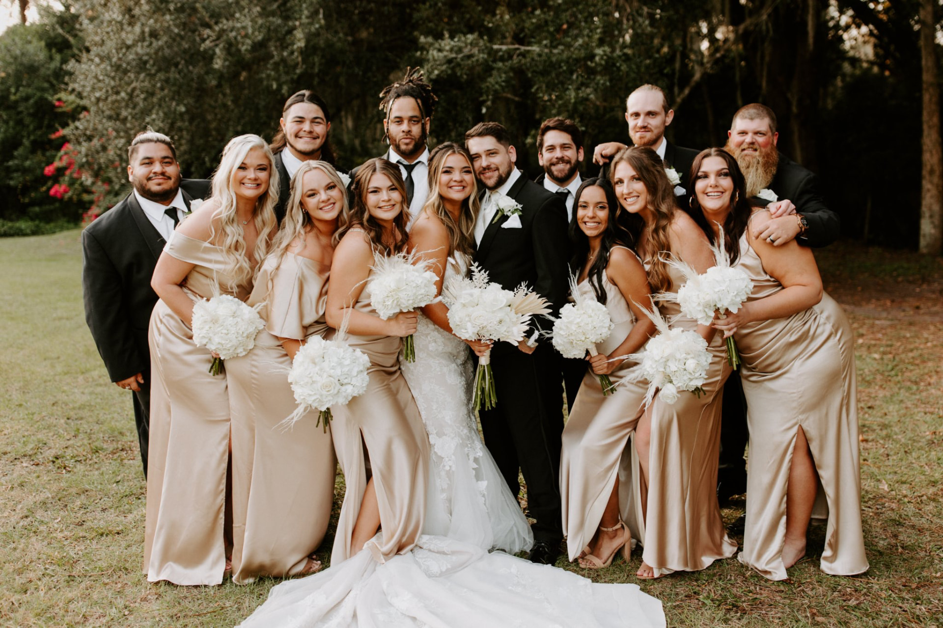 Bride and groom with their wedding party in a garden